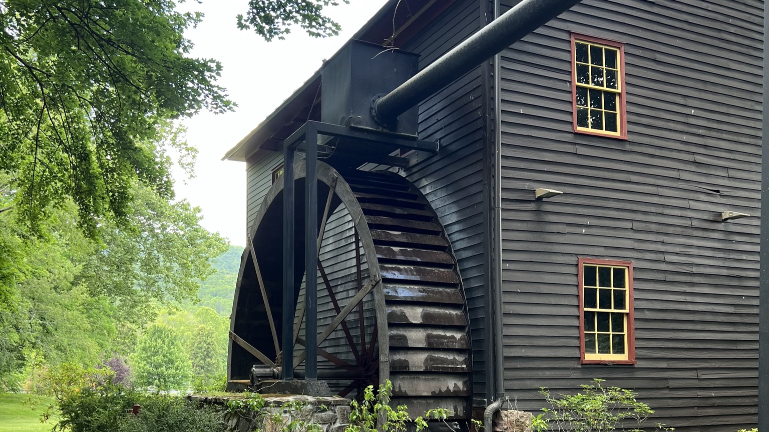 The dark wooden waterwheel and gristmill building at Tingler’s Mill