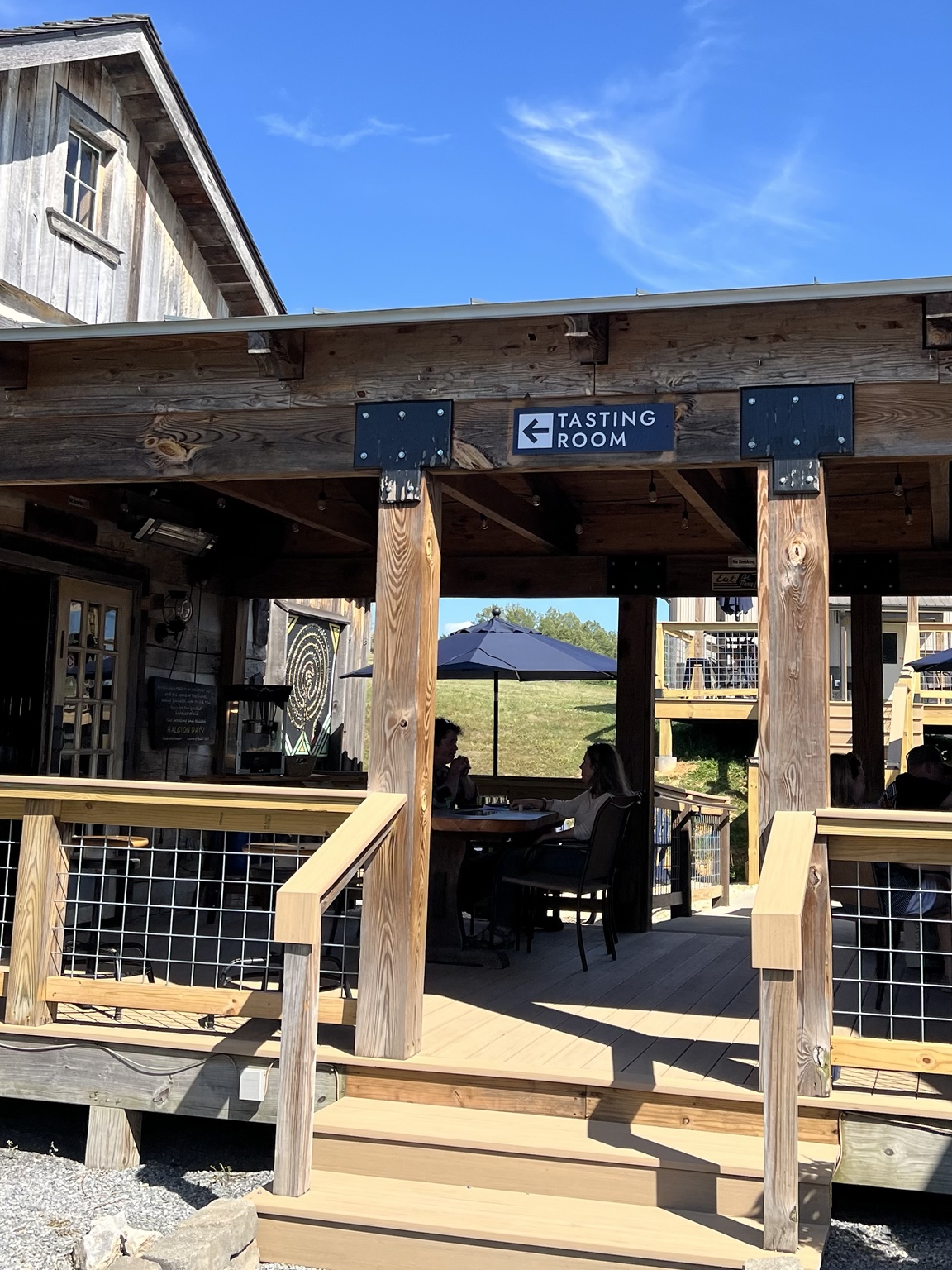 Covered outdoor seating beside the Halcyon Days tasting room.