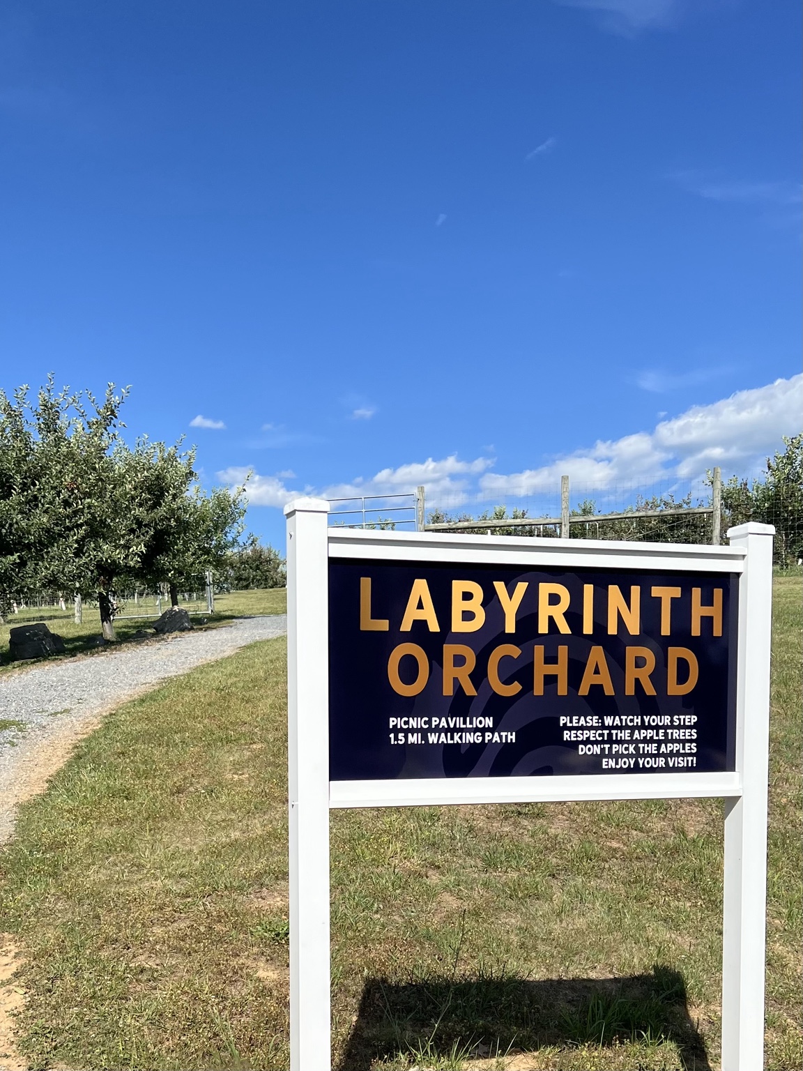 Labyrinth Orchard sign beside the mowed orchard path at Halcyon Days.