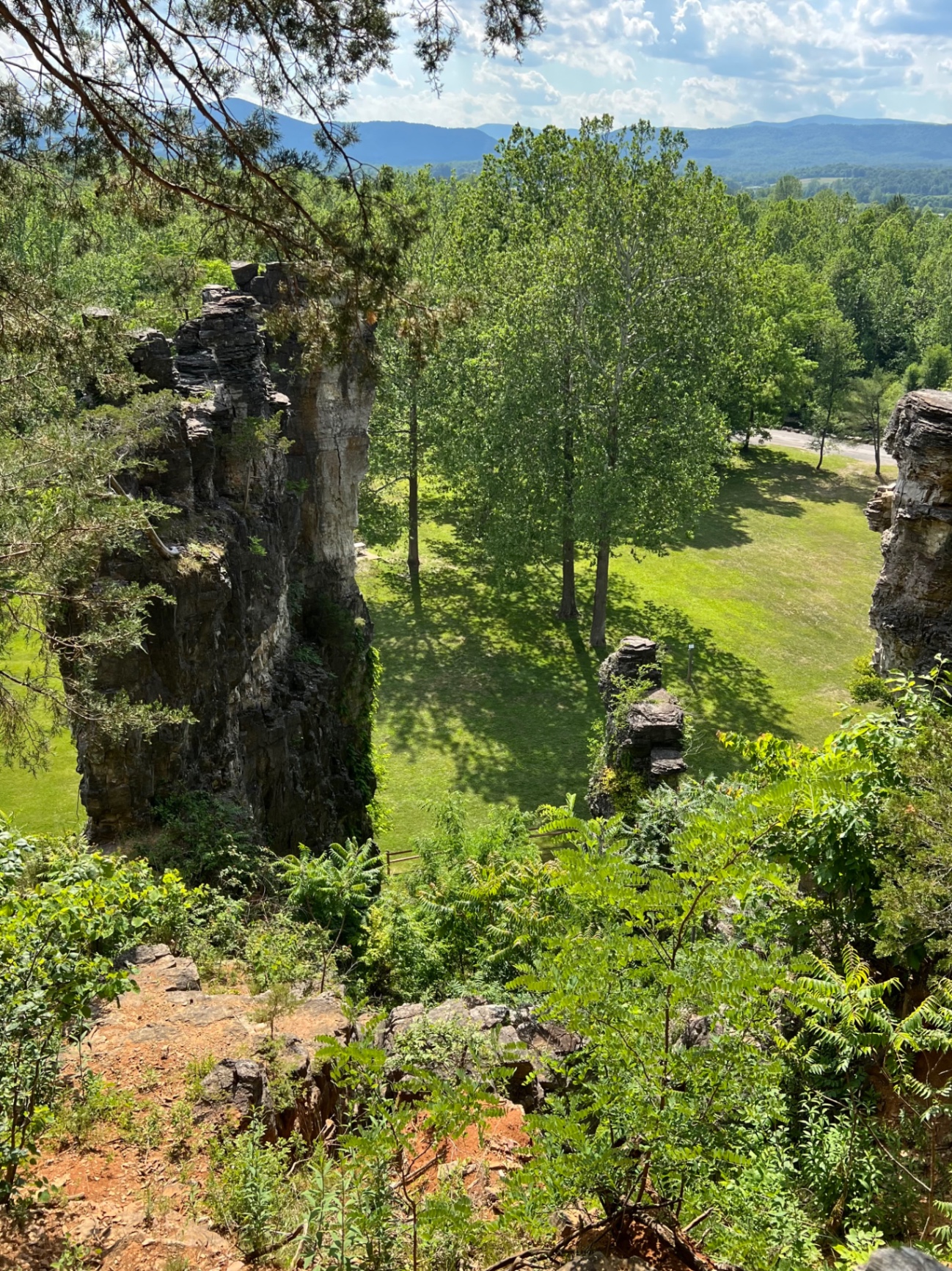 High-angle view looking down at the base of the limestone chimneys and the grassy park area
