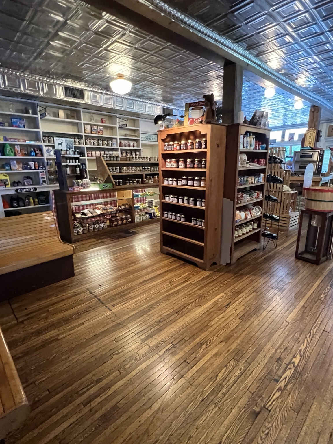 Inside the Paint Bank General Store, with tin ceiling, pine shelves stocked with local jams, and warm wood floors
