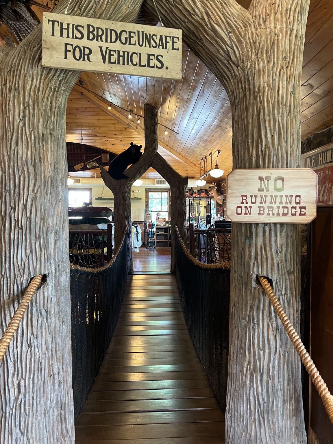 The entrance to the indoor swinging bridge on the second floor of the Paint Bank General Store, framed by carved tree trunks