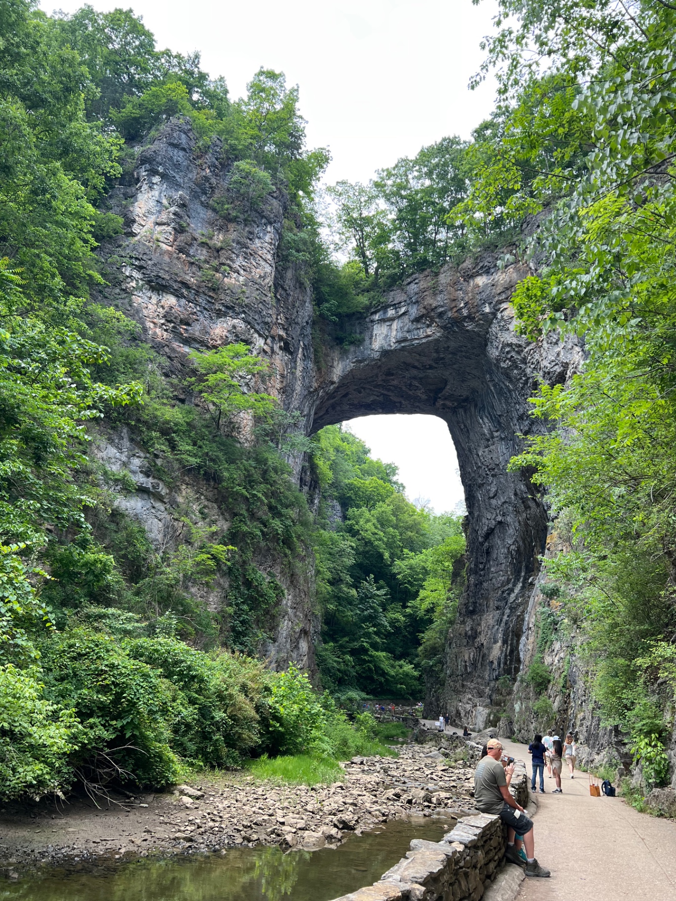 Looking up the length of Cedar Creek Trail toward the towering limestone arch of Natural Bridge